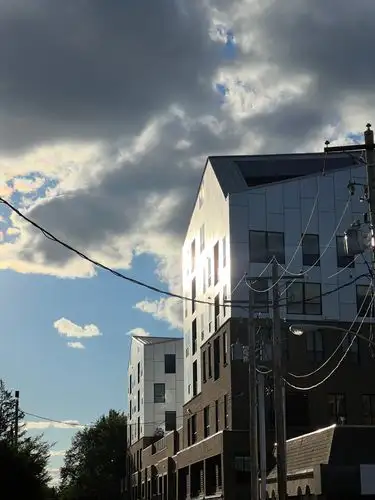 Sun-kissed modern buildings against a moody sky.